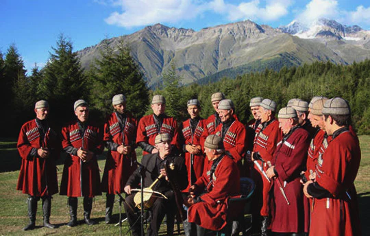Georgia’s intangible cultural heritage includes unique traditions, rituals, and forms of artistic expression passed down through generations. Notable examples are Georgian polyphonic singing, recognized by UNESCO in 2001 for its complex harmonies, and the ancient method of qvevri wine-making, reflecting centuries-old viticultural knowledge. Celebrations like Alilo and Giorgoba blend religious and folk elements, showcasing the deep connection between community, faith, and creativity. These traditions are a vital part of Georgia’s cultural identity.